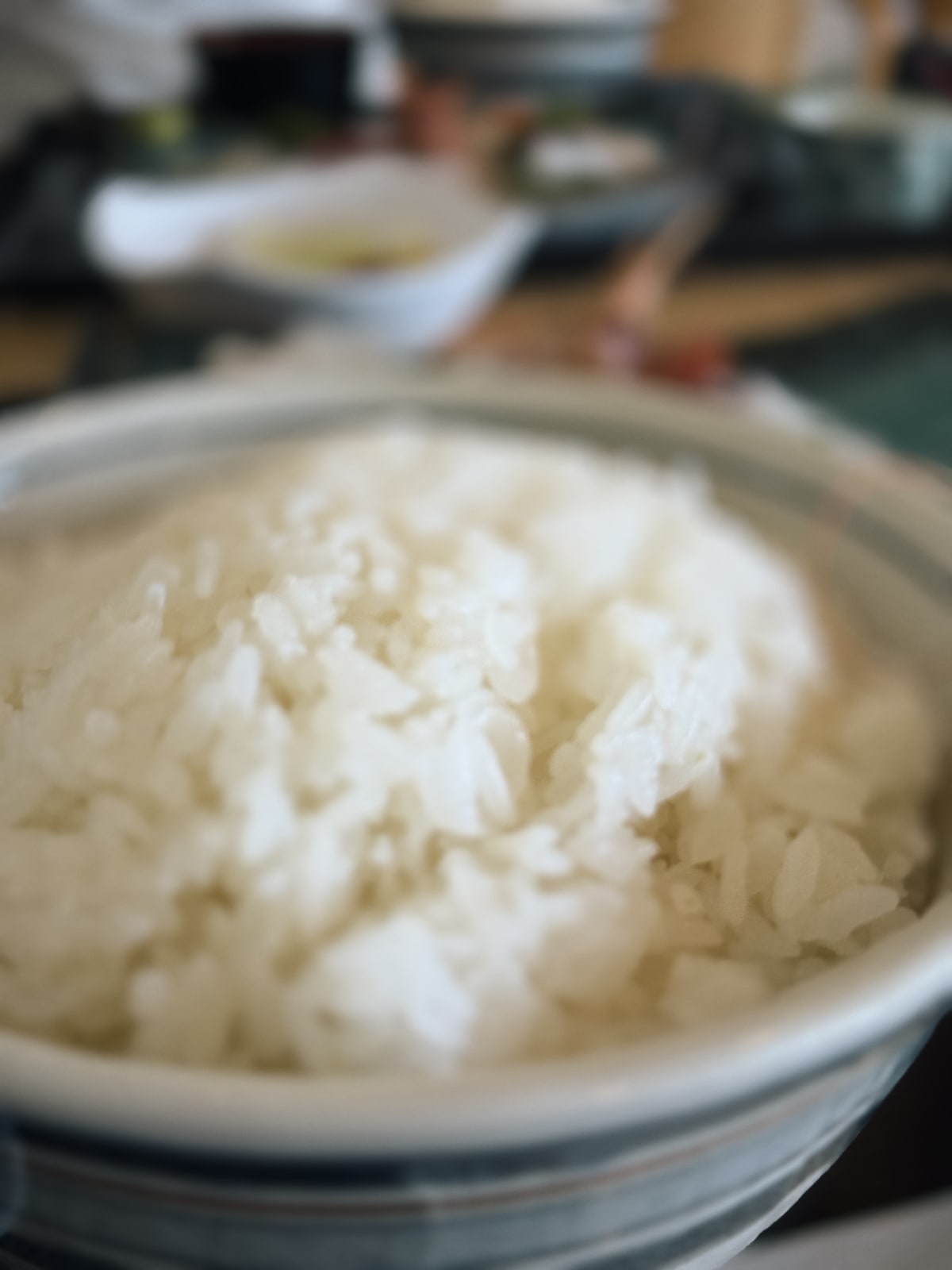 卓の上の椀に盛られた白い飯を寄って撮ったもの。